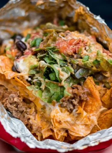 Delicious camping tacos prepared over a campfire with fresh ingredients.
