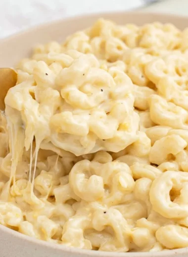 Creamy Greek yogurt mac and cheese dish garnished with herbs