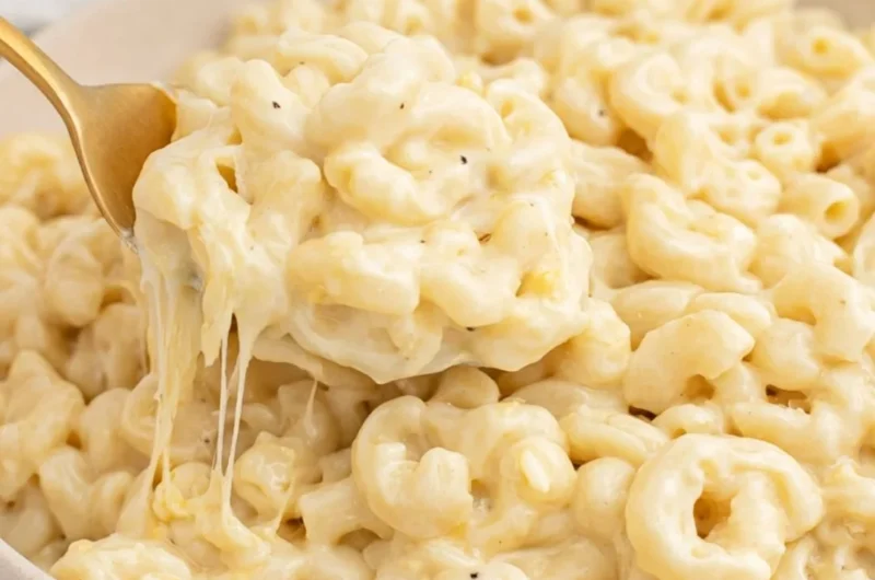 Creamy Greek yogurt mac and cheese dish garnished with herbs