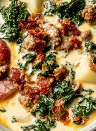 Bowl of creamy Tuscany soup garnished with herbs and bread