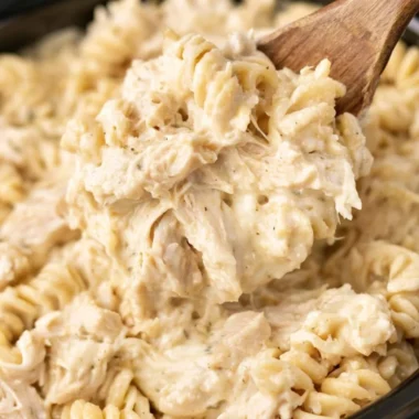 Crockpot Garlic Parmesan Chicken Pasta served in a bowl with herbs garnish