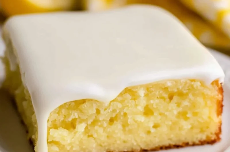 Lemonade cake topped with fresh lemon slices and a light glaze